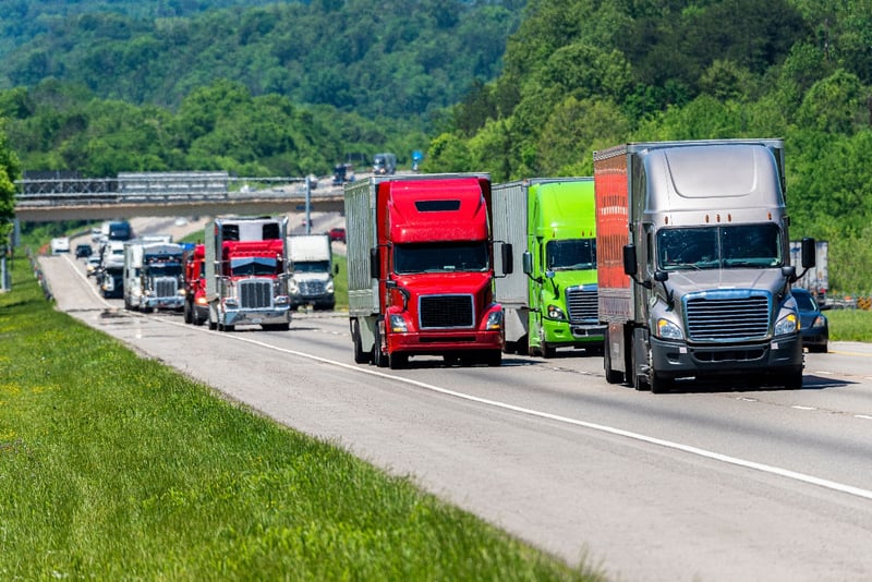 Heavy traffic with several semi-trucks driving down a highway in Tennessee.  