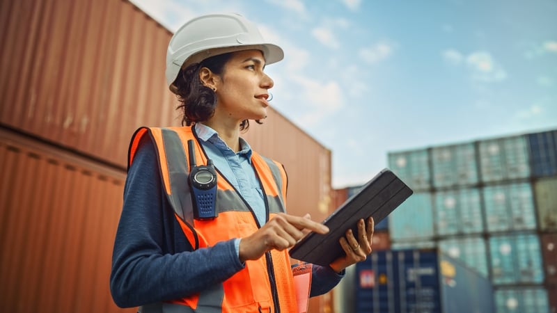 A female employee uses Optimal Dynamics on a tablet to improve carrier performance.